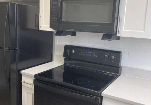 Modern Kitchen with white quartz countertop and black oven